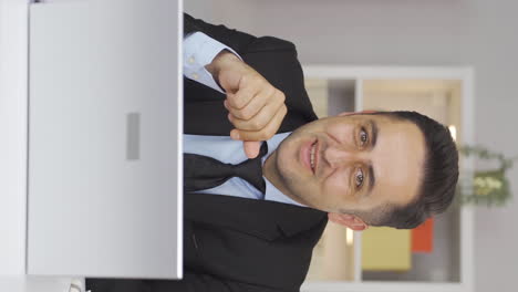 Vertical-video-of-Home-office-worker-man-expressing-his-mind-and-success-to-the-camera.