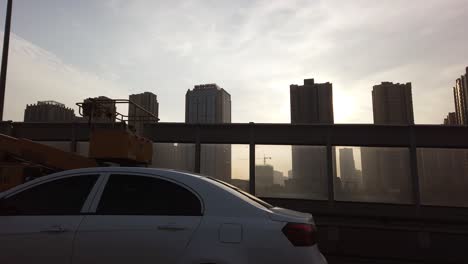 fast highway going through the high-rise blocks of flats suburb in the city of xian in summer morning, shaanxi province, central china