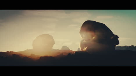 huge golden statues in the desert during sunset