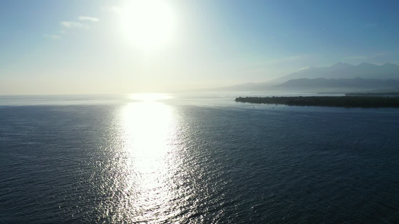 배경에 작은 섬이 있는 바다의 아름다운 열대 일몰