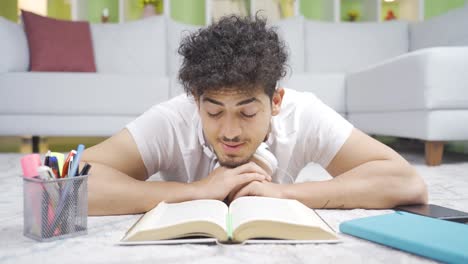 close-up of male student reading a book.