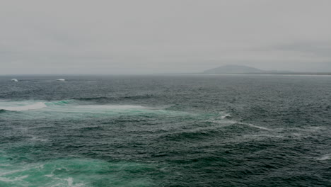 Aerial-drone-flying-over-a-stormy-ocean-off-the-south-coast-of-NSW,-Australia