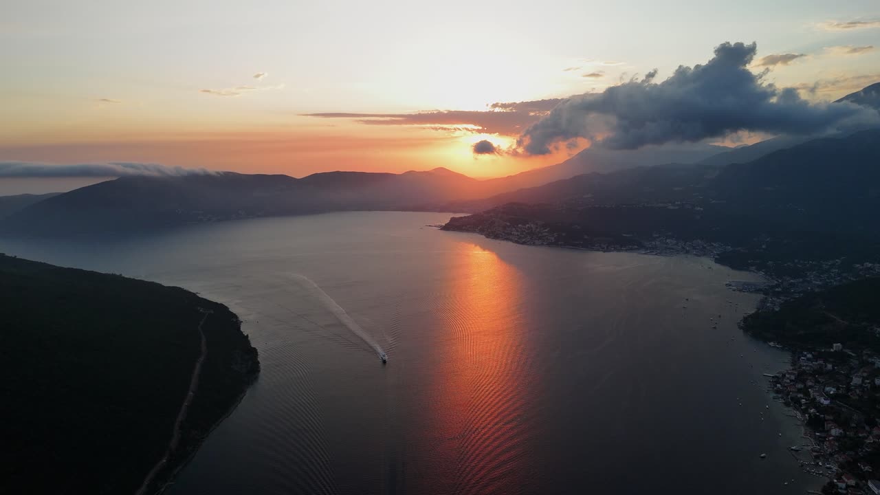 Golden sunset beam reflects off Kotor Bay: Aerial over Portonovi, MNE