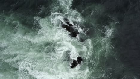 a view of crashing waves on outcrops during stormy weather