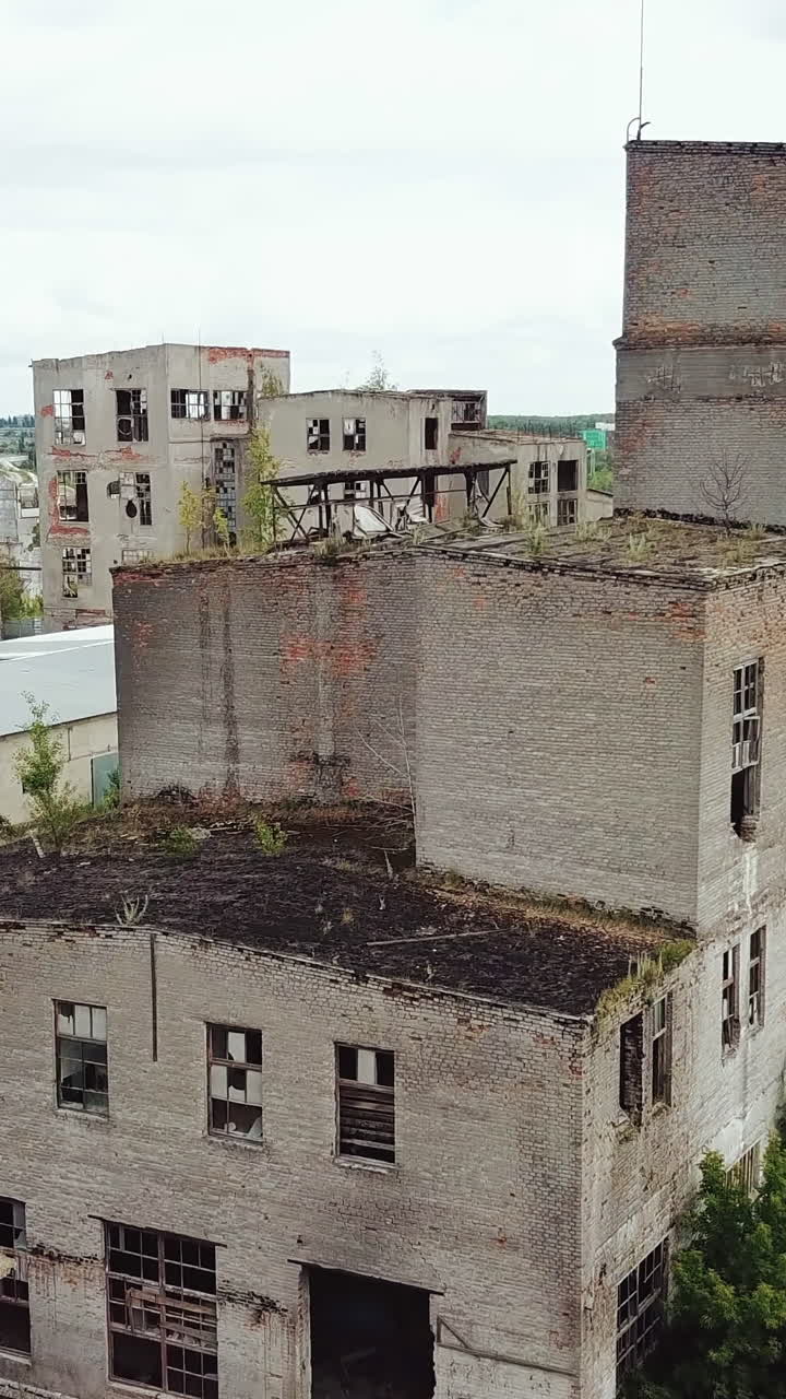Abandoned ruined industrial factory building, ruins and demolition concept. Aerial view. Vertical video
