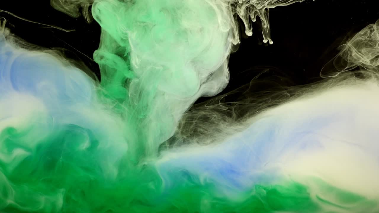 Abstract forms. Shooting on a black background. Mixing of paints