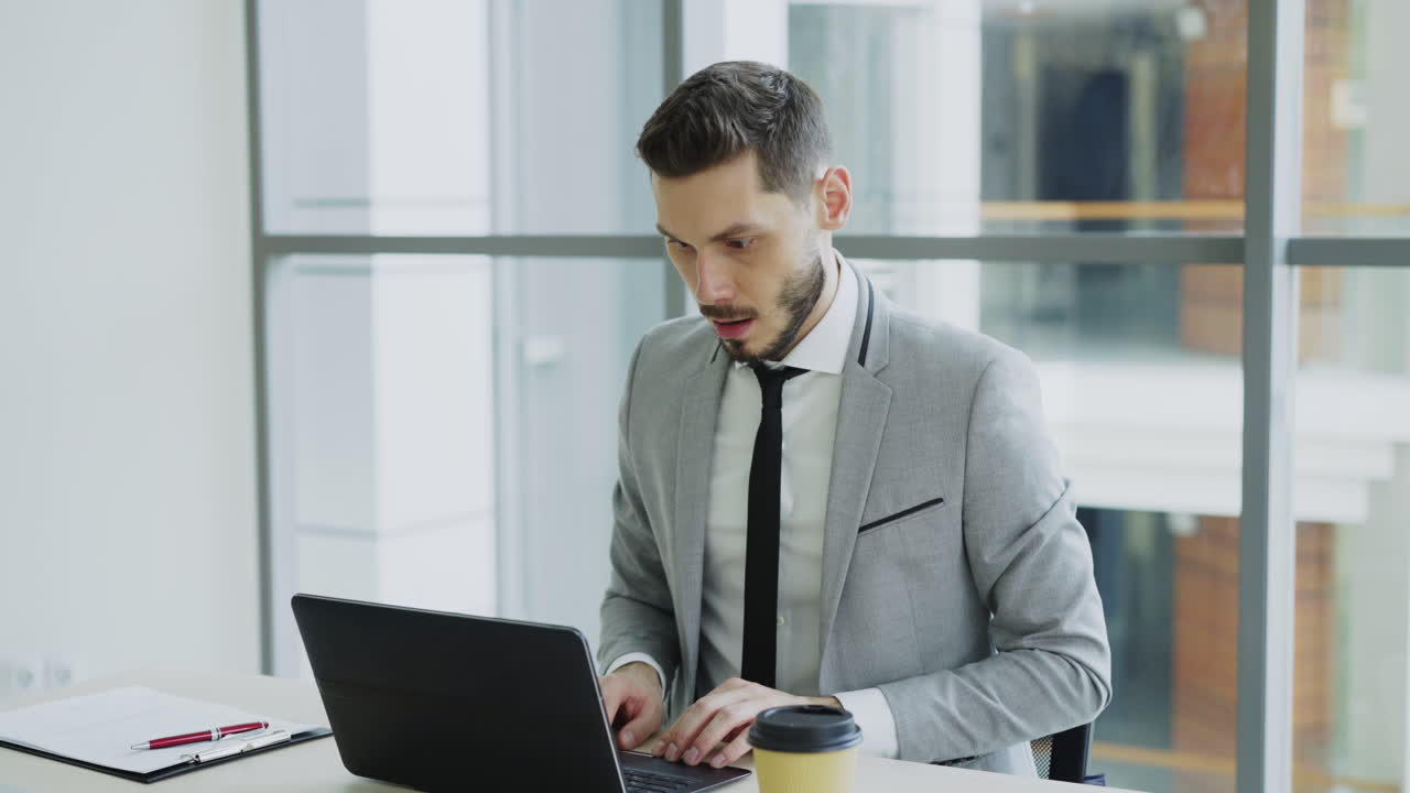 Happy Businessman Celebrating Success at His Desk