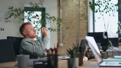 young man flirting colleague sitting office together closeup. guy throwing paper