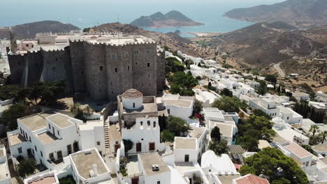 Greece, Patmos Island, Drone Footage of the holly castle monastery surrounded by the smaller chapels and churches. Footage turns slightly from left to right. Picturesque island with beautiful scnery.