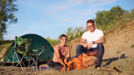 couple camping by a river