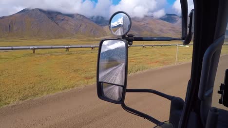 view of the trans-alaska pipeline from a motor home driving on the dalto highway