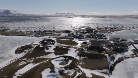 aerial view of idyllic winter landscape of iceland on sunny winter day, frozen lake and volcanic crates