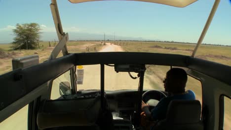 pov shot driving in an open topped safari vehicle through africa 1