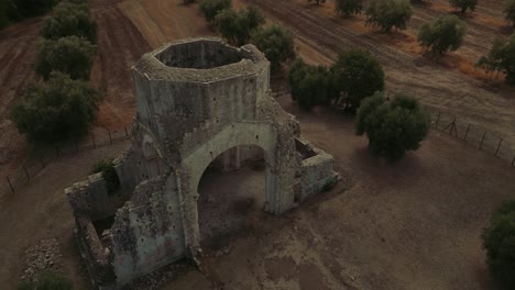 Medieval-monastery-abbey-church-Abbazia-di-San-Bruzio,-an-old-damaged-abandoned-ruin-in-Tuscany-from-the-11th-century-Middle-Ages-surrounded-by-olive-trees-in-Italy