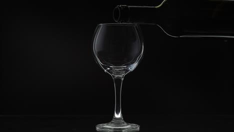 pouring red wine into a glass