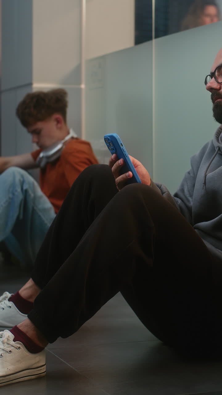 Young people using mobile phones in a public space