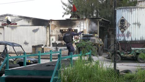 swat actor throwing a grenade to a tank as tank fires a shot on industrial terrain, dream world