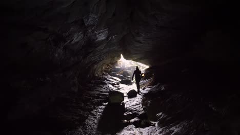 static, person walking towards luxmore cave exit, kepler track new zealand