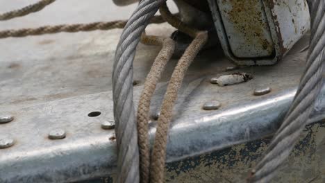 close-up of rusty metal with cables and ropes