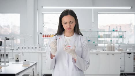 confused indian female scientist doing experiments