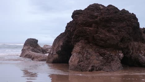 tide coming in around rock formations on this oregon coast beach