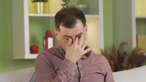 the man experiencing eye pain starts rubbing his eyes.