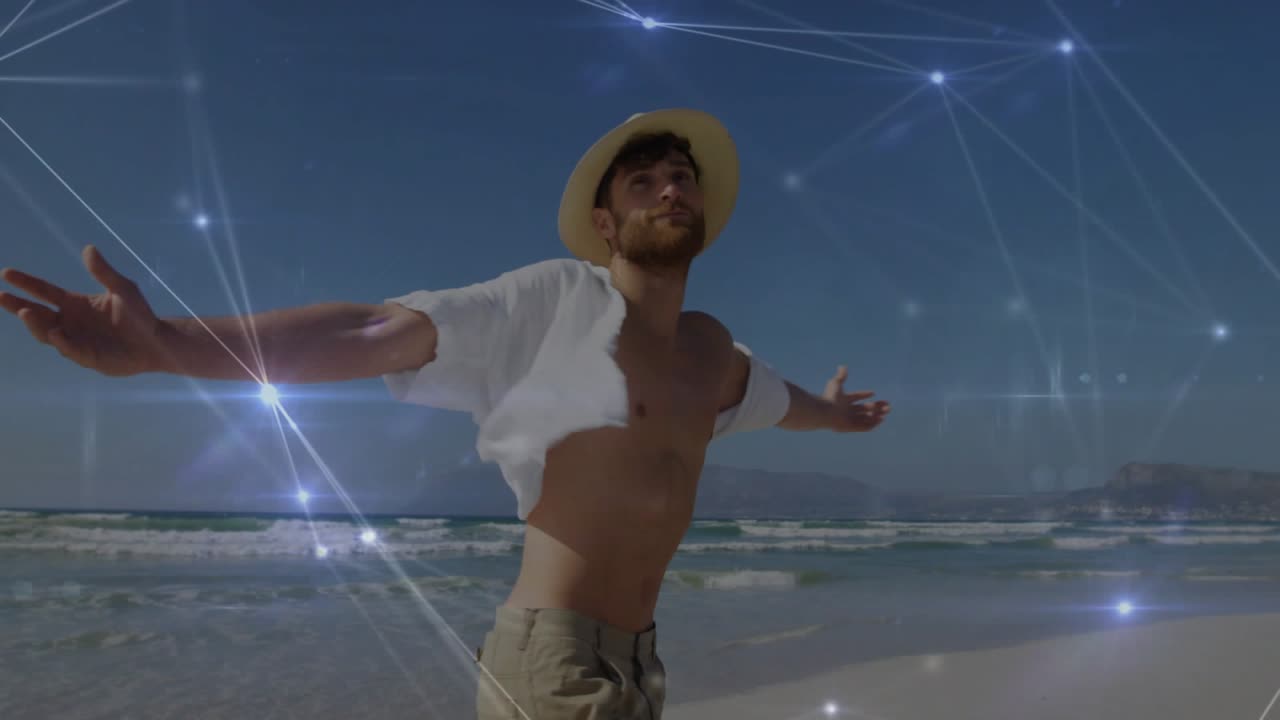 Man extending arms and turning on sandy shore, glowing network aligning with hands for tech demo