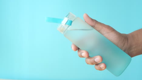 a person holding a blue water bottle