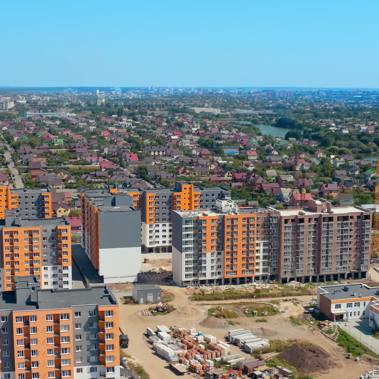 Modern architecture in the city. High rise buildings. Multi-storey buildings built in rural area near the river. View from above