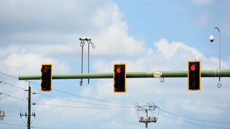 timelapse-of-traffic-lights-and-traffic-surveillance-systems-on-a-rolling-cloud-day