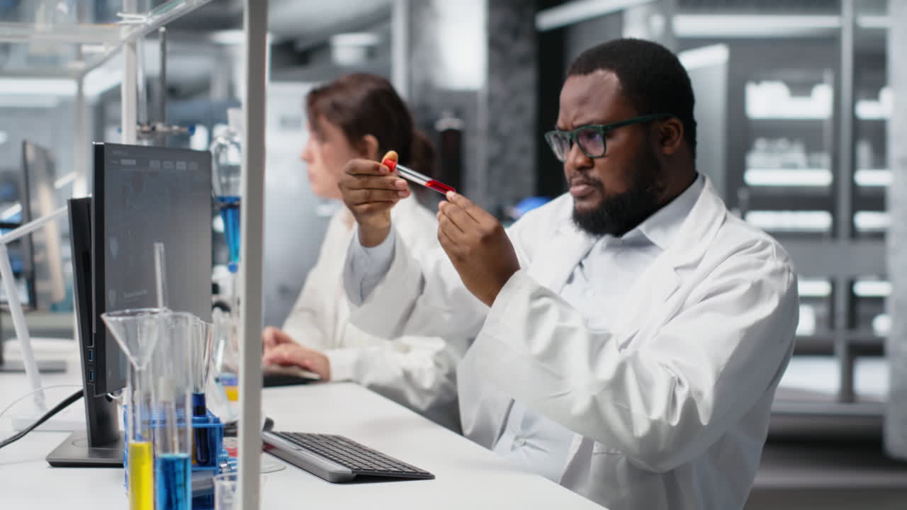 Vertical video Quality control analyst in lab testing blood sample using computer