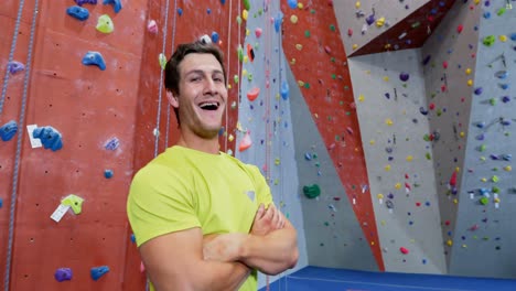 Confident-man-standing-with-arms-crossed-in-fitness-studio-4k