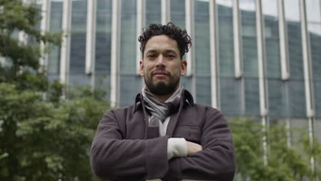 Hispanic-ethnicity-male-with-cheerful-and-confident-expression-looking-at-camera-in-open-air-outdoors