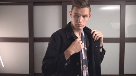 portrait of a confident young man wearing black corduroy jacket