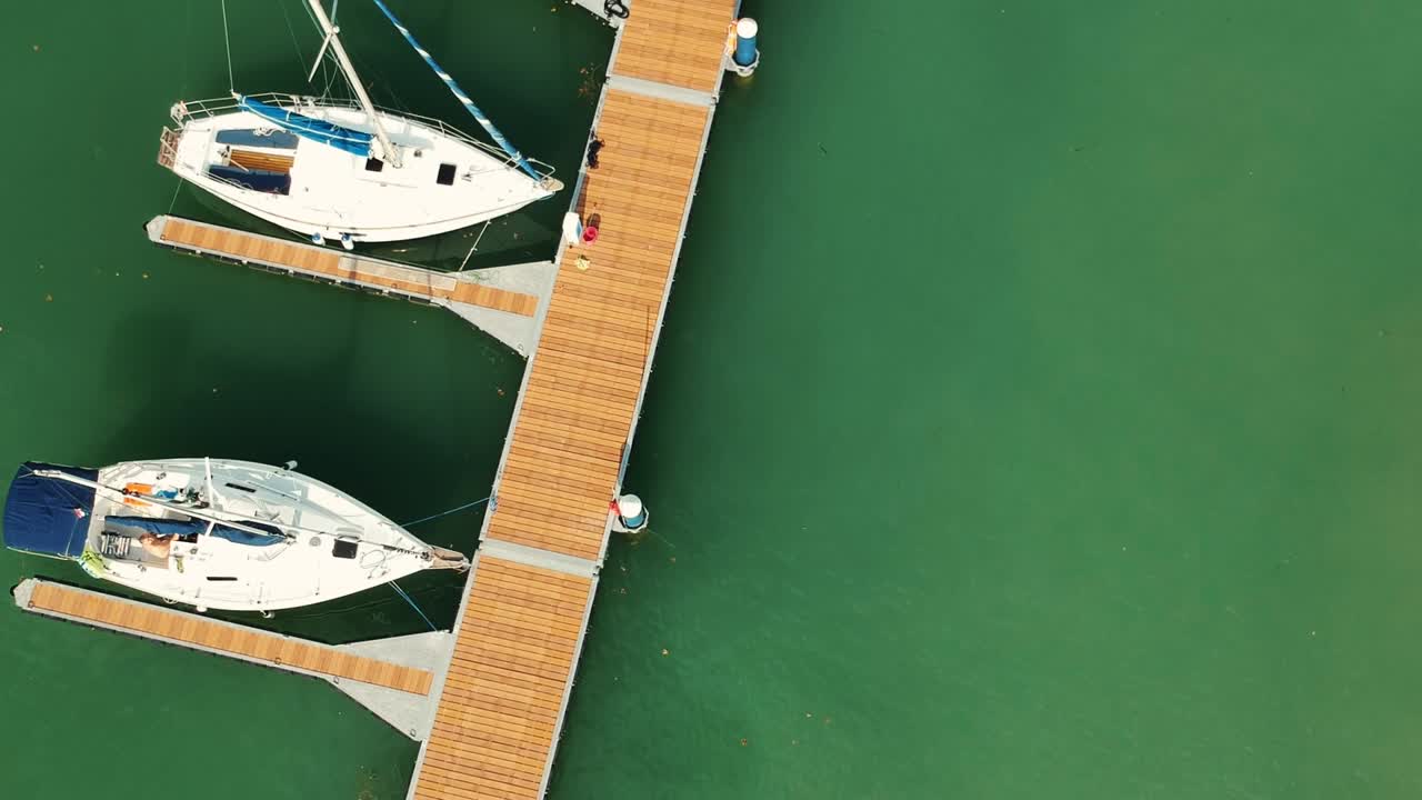 Drone footage of Balaton dockyard and its little bay, beautiful green water and ships everywhere.