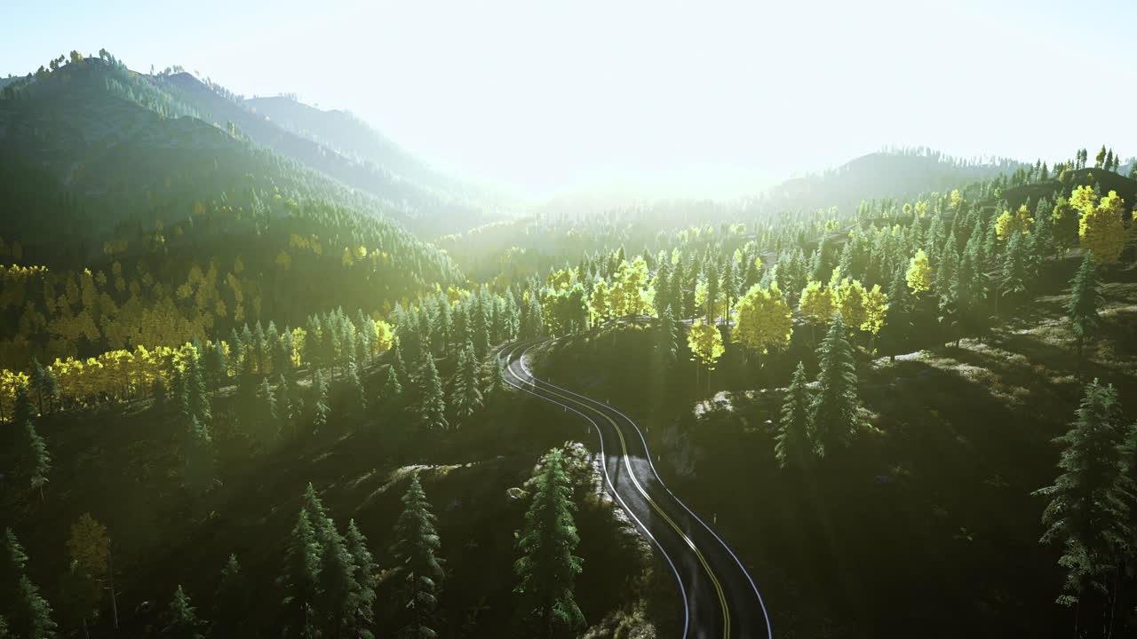 Scenic view of winding train tracks through lush mountains during golden hour