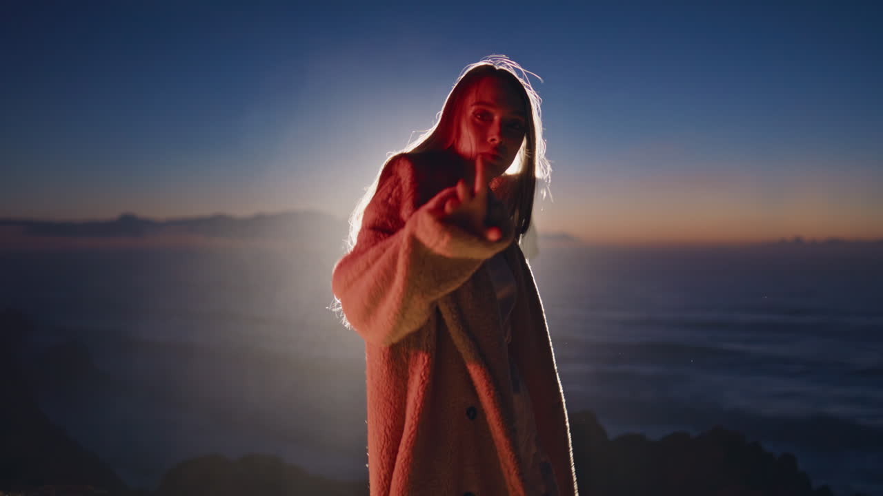 Neon woman dancing evening in fur coat closeup. Seductive lady looking camera