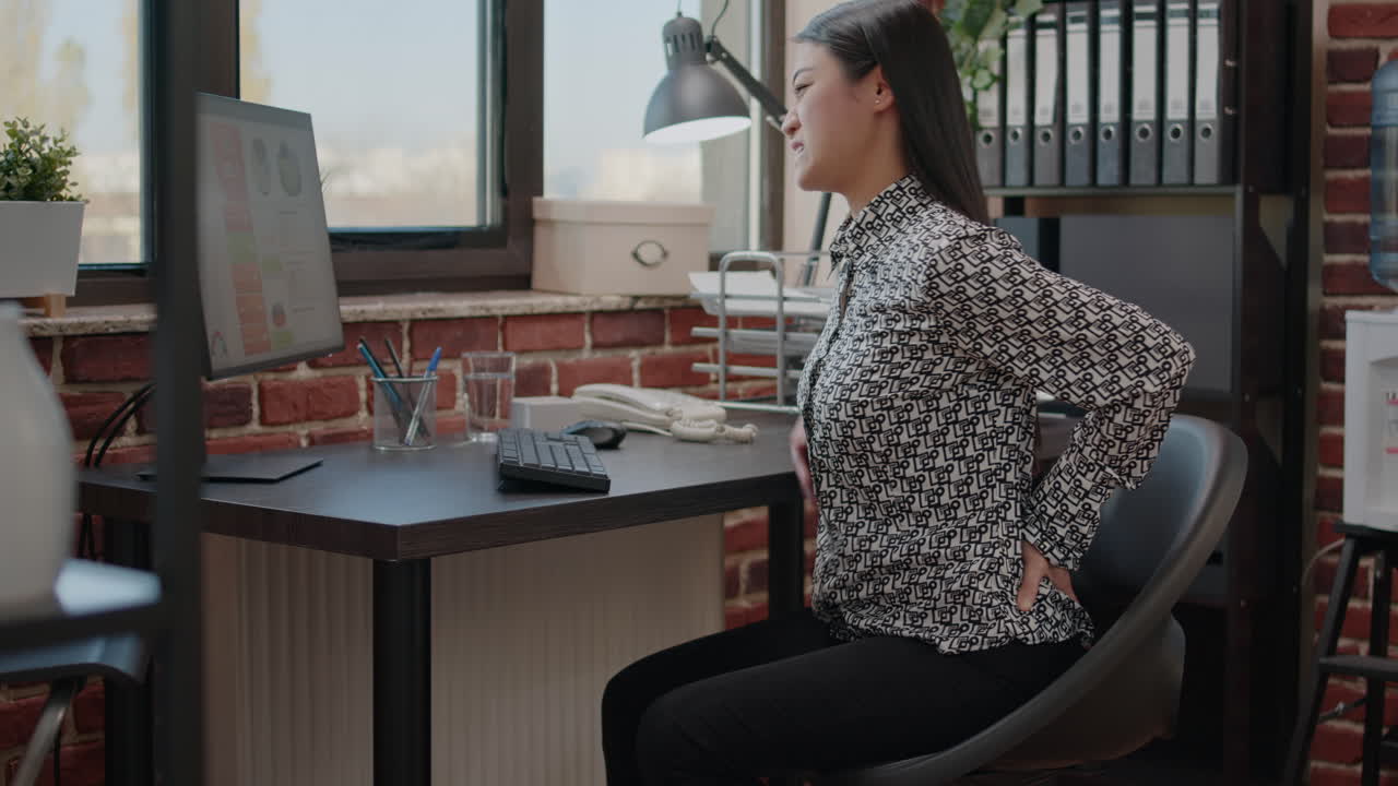 Asian person suffering from spine and back pain