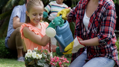 Mother-and-her-daughter-watering-plants