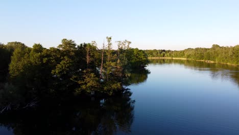 middle of the lake small island
tranquil aerial view flight slider fly sideways from left to right drone footage
in brieselang germany europe at summer 2022