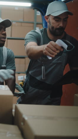 warehouse workers scanning boxes and managing inventory