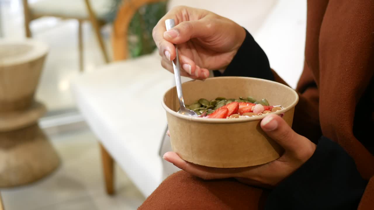 Woman eating a healthy smoothie bowl
