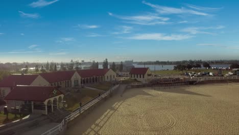 Aerial-drone-slow-descending-shot-of-Nobbys-beach-and-Surf-Life-Saving-Club,-Newcastle,-Australia