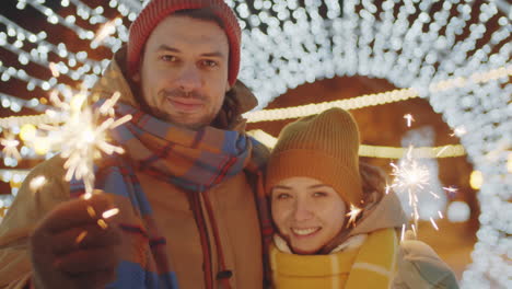 Portrait-of-Romantic-Couple-with-Sparklers-in-Tunnel-of-Lights