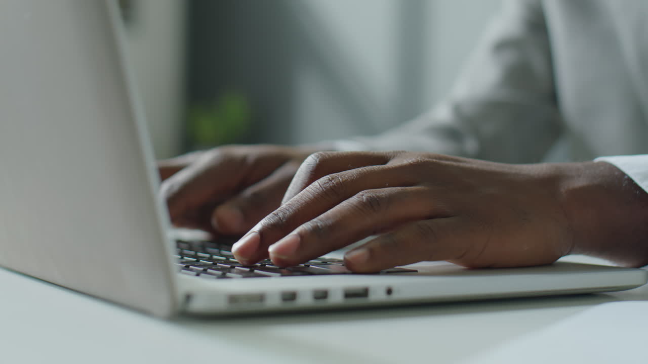 Hands of Black Businessman Working on Laptop