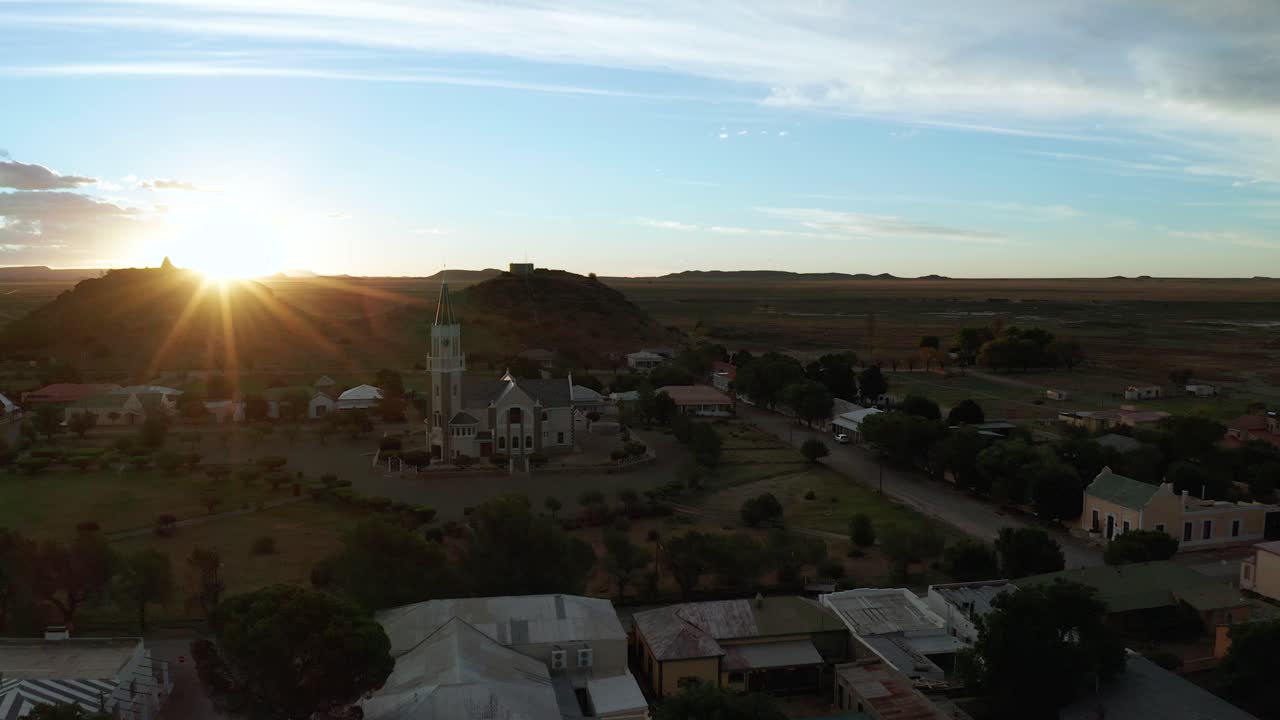 Cute little rural town in desert of South Africa, aerial flying forward, sunset