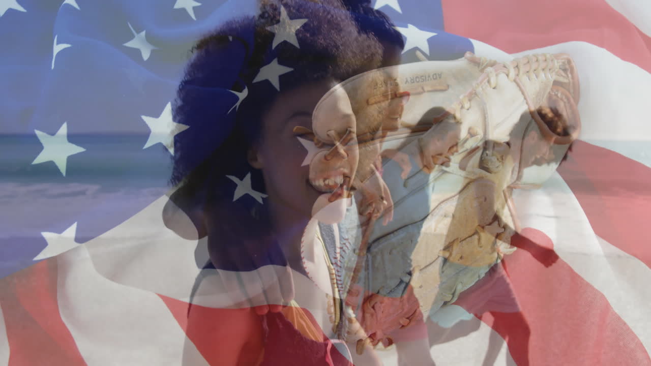 At beach, couple smiling holding baseball glove, animation of American flag