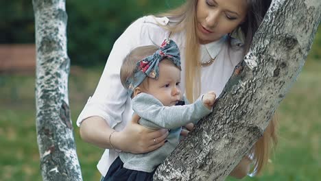 young beautiful mother is holding a little baby