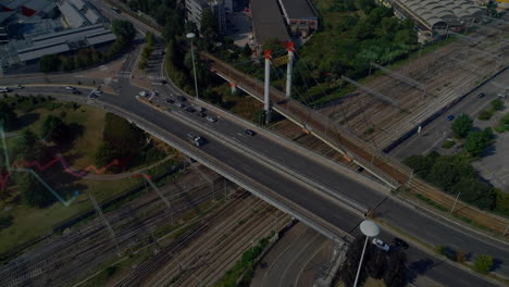 busy highway intersecting railway tracks in urban area, animation of city traffic