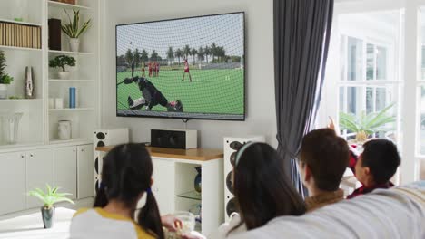 composite of happy family sitting at home together watching hockey match on tv